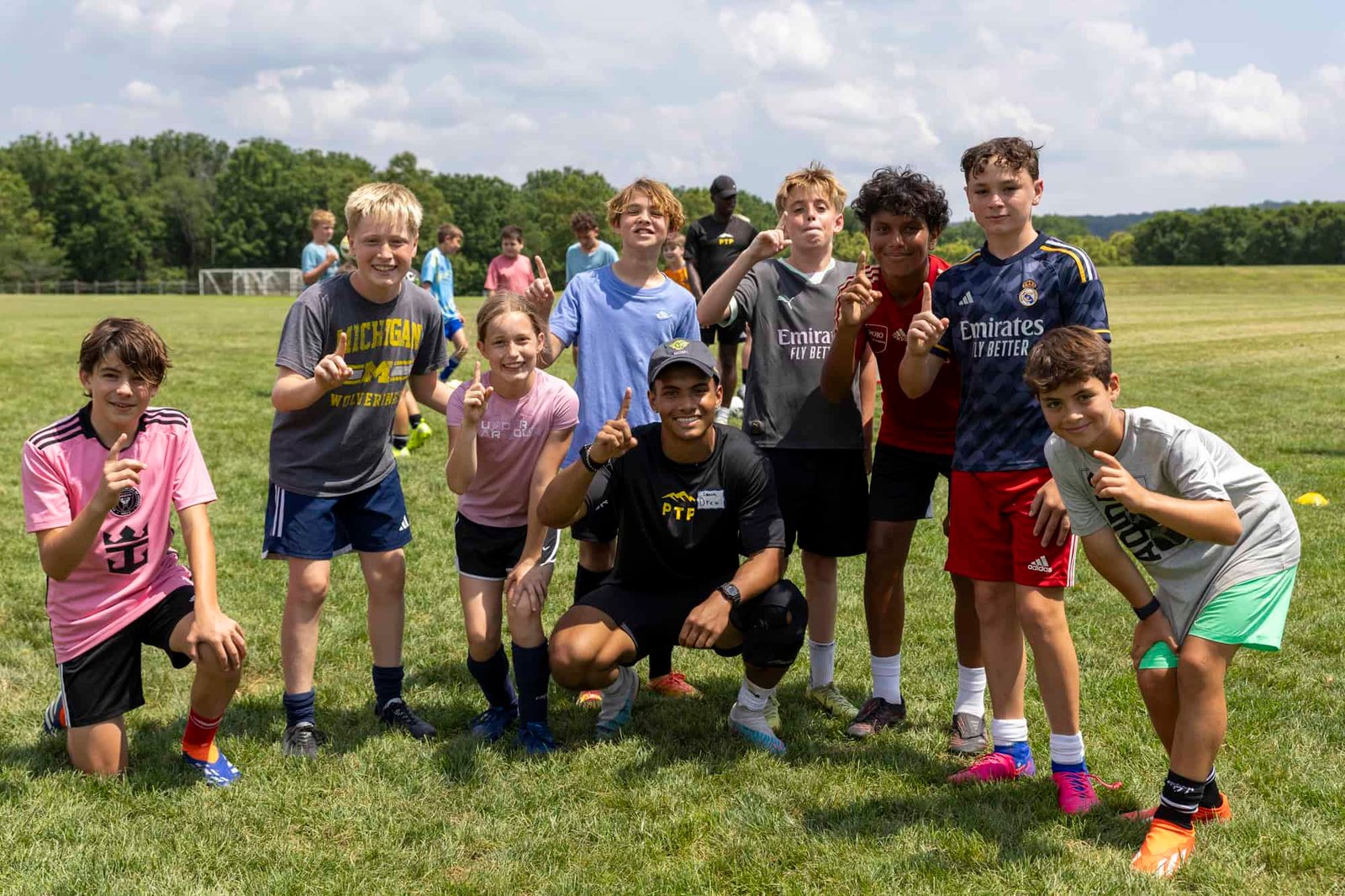 Players celebrating at a PTP soccer camp