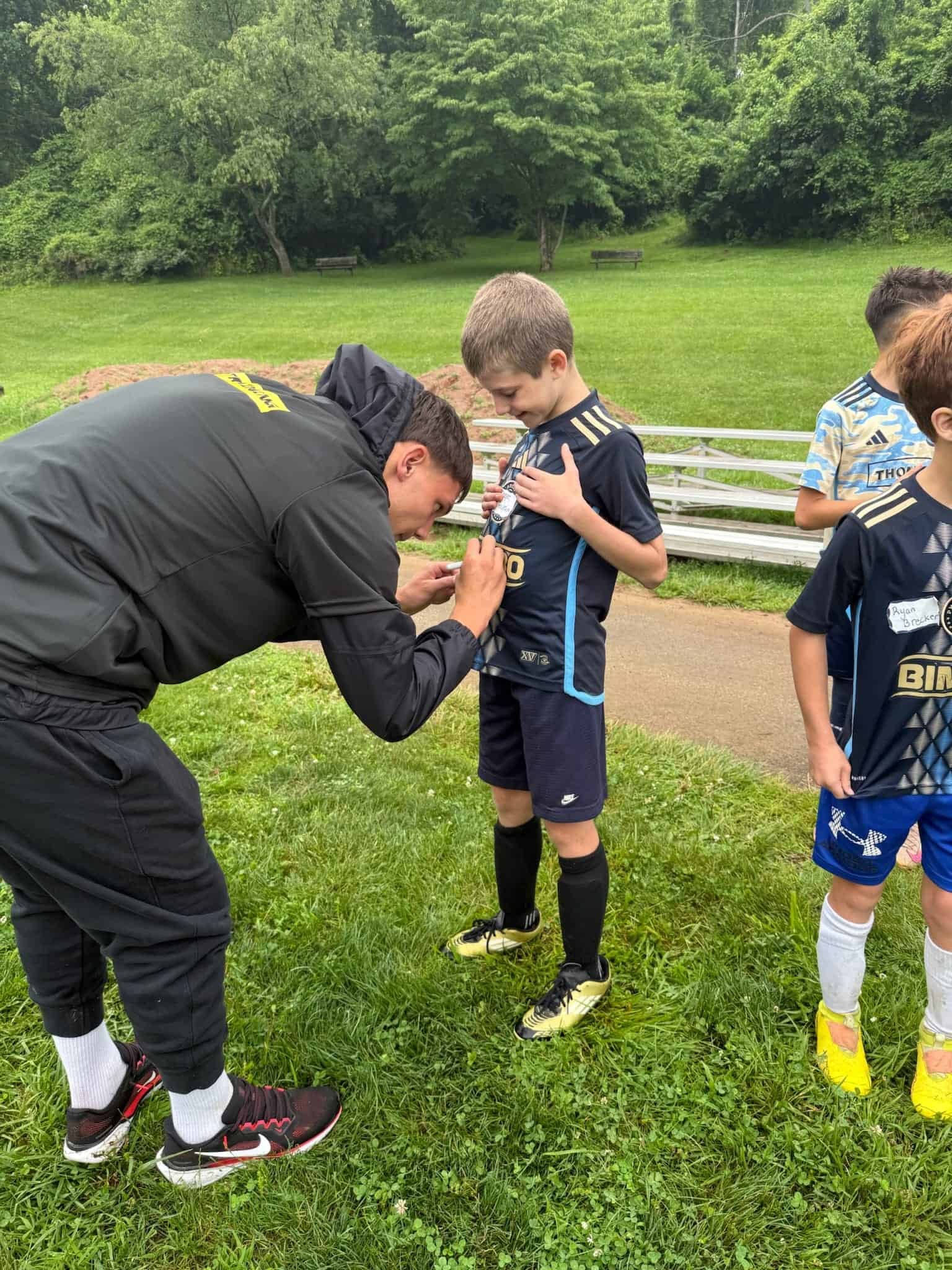 NCAA athlete coach working with youth player at PTP camp