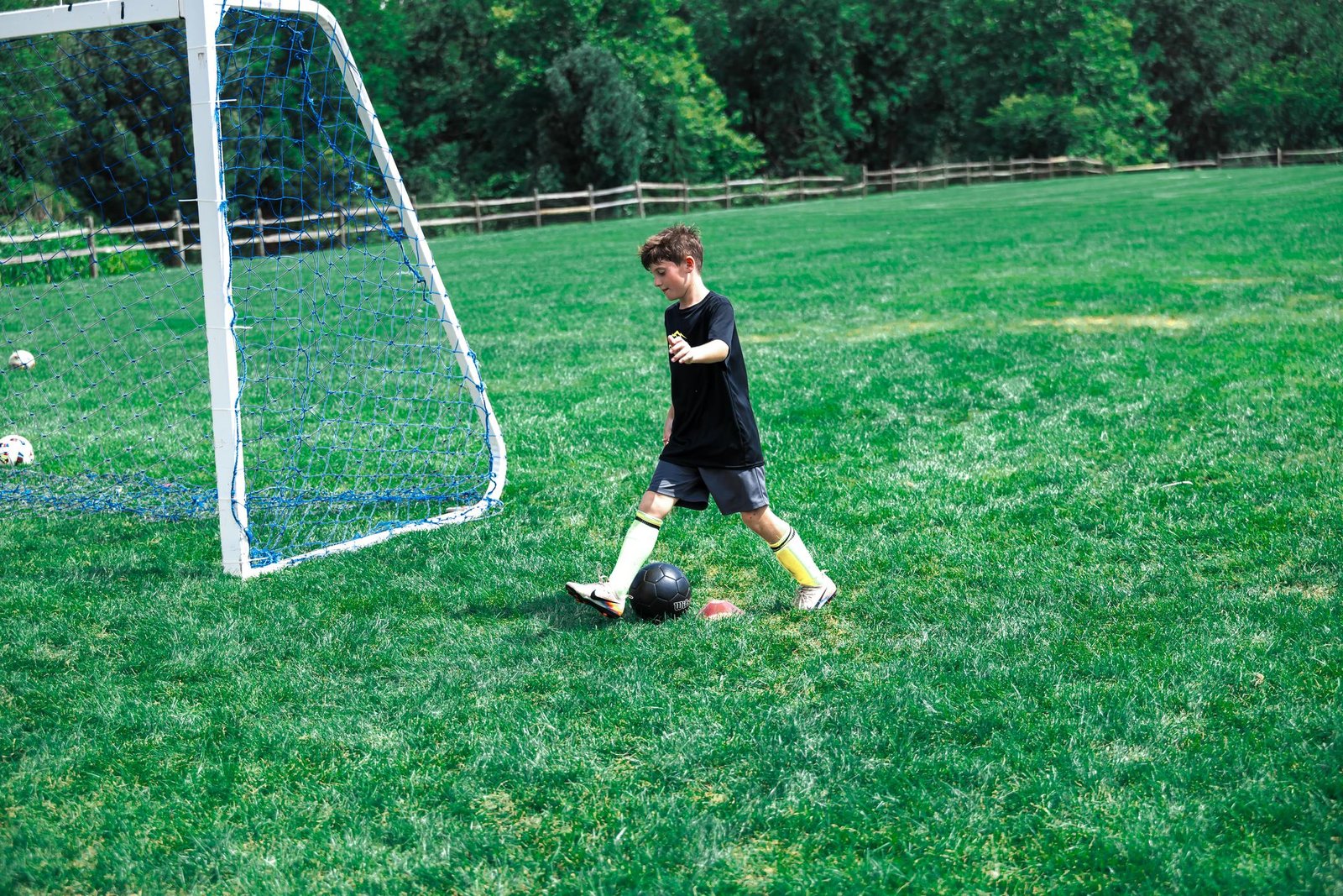 Camper controls a ball beside the goalpost